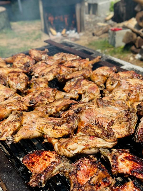 Close-up of chicken grilling over an open fire