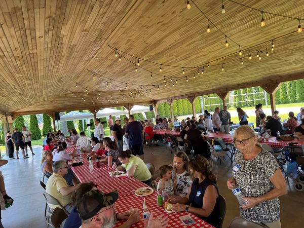 Families at the pavilion tables enjoying the picnic