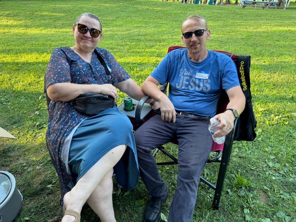 A couple relaxing in lawn chairs in the evening sun